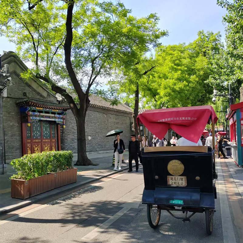 Traditional rickshaw ride through old Beijing Hutongs, a classic cultural experience for private tour guests.
